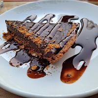 Chocolate Caramel Tarte served on a graham base, garnished with caramel and pecans 😍🥰😋🎉 at Lola Rosa - Places des Festivals in Montreal