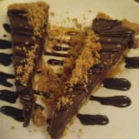 Tarte choco-caramel sur croûte de pacanes et riz croustillant. at Lola Rosa - Places des Festivals in Montreal