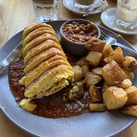 Breakfast burrito with potatoes and maple baked beans. So good! at Lola Rosa - Places des Festivals in Montreal