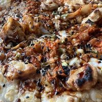 The surface of the Thai chick’n bbq delish pizza  at Big Slide Brewery in Lake Placid