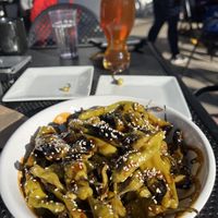 Shishitos and a beer outside   at Big Slide Brewery in Lake Placid