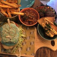 Koocha fried chicken burger (blue bun), sweet potato samosas, kotlet (mince/potato patties in a mint chilli salsa), gaymeh (aubergine & yellow split pea stew) & okra fries.   at Koocha Mezze Bar in Bristol