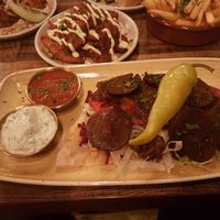 Kebab in foreground mezze stuff in background at Koocha Mezze Bar in Bristol