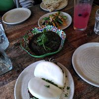 From top: plain bread, roasted broccoli, ghormeh sabzi, and bao buns at Koocha Mezze Bar in Bristol