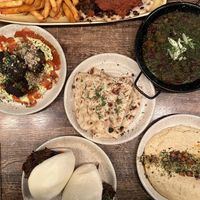 Bao buns with Döner meat, hummus, bread, a bean stew and some spinach balls.   at Koocha Mezze Bar in Bristol