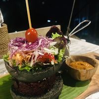 OM burger on a black rise bun at OM Burger in Pecatu