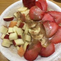 Porridge bowl with extra strawberries  at Happy Blender in Athens