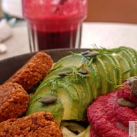 Nourishing Buddha Bowl”: “Organic red bean and quinoa ‘meatballs,’ avocado, zucchini noodles, beet hummus, chickpeas, pumpkin seeds, and beet sprouts. at Happy Blender in Athens