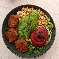 Nourishing Buddha Bowl”: “Organic red bean and quinoa ‘meatballs,’ avocado, zucchini noodles, beet hummus, chickpeas, pumpkin seeds, and beet sprouts. at Happy Blender in Athens