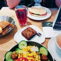 Falafel salad (small) served with bread, cappuccino with soya milk, vegan brownie, vegan blueberry ice tea and a panini with prosciutto at Mischbar in Nuremberg