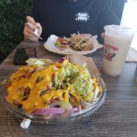 Front: Ultimate vegan nachos with guac, Back: Ultimate vegan torta and vegan horchata at Guacamaya Oasis in Downey