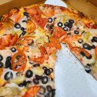 Custom pizza - tomato, artichoke, olives and vegan cheese at Troy's Italian Kitchen in Arlington