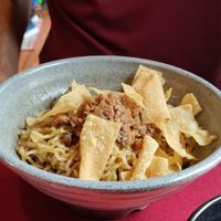 Traditional noodle dish with soy meat and crispy things at Rumah Juliet in Jakarta