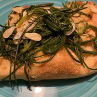 pizza with chickpea hummus, agretti and almonds at Pane e Tempesta in Rome