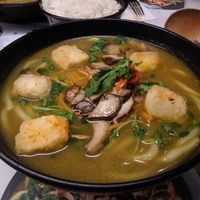 Kare Burosu Ramen [£10.95] – (Vegan) shichimi-coated silken tofu and grilled mushrooms on udon noodles in curried veg broth, topped with pea shoots, carrot, chili, coriander at Wagamama in Guildford