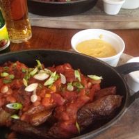 Vegan smokey bean chilli with nacho cheese sauce and cumin almond yoghurt at The Crown and Anchor in Barnsley