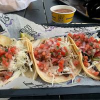 Corn tacos with (from left to right) mushrooms, tofu (ie plant fare), seitan steak. Topped with cabbage and pico de gallo. Bean dip is vegan without cheese. Queso dip blacked out.  at Taco Bus in Clearwater