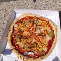 Vegan pizza: vegan mozarella, BBQ base, jalapenos, sweetcorn, spiced Cauliflower, nduja vegan sausage at Pizza Punks in Belfast