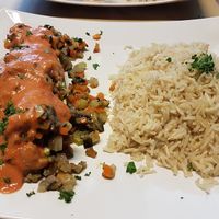 courgette, stuffed with brunoise of eggplant, chestnut mushrooms and other vegetables with tomato-soycream sauce, with rice (17€). at Cafe Manger in Leuven