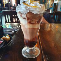 Large sundae in glass. Whipped cream, chocolate buttons and crystallised orange on top, with layers of chocolate orange and vanilla ice cream and chocolate sauce at the bottom.  at Church - Temple of Fun in Sheffield