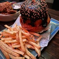 Onion ring burger and in the background mushroum crisps at Church - Temple of Fun in Sheffield
