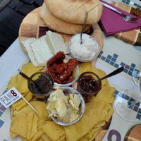 Olive paste, dried tomatoes and onion jam. More cheese and hot tasty bread at Pan8 in Bologna