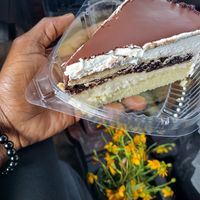Chocolate layer cake. As good as it looks!! (Pericon flowers) at TNK Vegan Cafe in Modesto