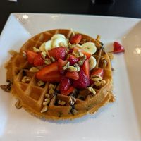 Vegan waffle with blueberries mixed in and strawberries, bananas, and walnuts on top at Waffles INCaffeinated in Beaver