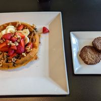Waffle with side of plant based sausage at Waffles INCaffeinated in Beaver