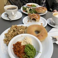 Vegan savory breakfast plate, vegetarian in the back, flat white, americano, vegan croissant  at Massolit Cooks in Krakow