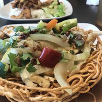 Chow mein and lemongrass seitan rice in the background  at Goji Cafe in Dallas