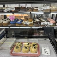 Display case of cupcakes and vegan cheese rolls   at Cake Girl in Los Angeles