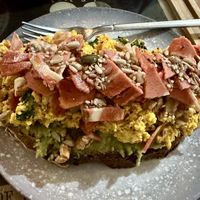Delicious toast with avocado, tofu scramble, and other tasty toppings 😋   at La Tienda de Los Unicornios in Granada