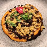 vegan gnocchi with porcini mushrooms & black garlic on a pumpkin cream sauce & crispy chips at Ristorante Lo Stornello in Stresa