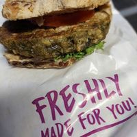 "Malzkornspitz", green oat patty with some spread and 1 tomato slice (4.90€) at Quicker's in Frankfurt