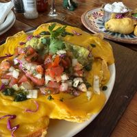 Vegan cheesy Nachos and Vegan chilli poppers in the background  at The Fat Cactus - Gardens in Cape Town
