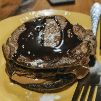 Banana pancakes with pb and chocolate sauce. So good!  at Capra in San Jose