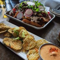 Fried pickles and loaded fries with shiitake bacon at ERIS Brewery and Cider House in Chicago