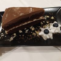 Chocolate cake with coconut whipe cream  at Giusto Restaurante Vegano in Torrevieja