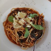 Pasta with dry tomato, fresh mushrooms, rúcula, artichoks and tomato sauce with oregano at Pane & Vino in Evora