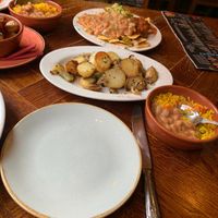 Tapas sides of potatoes, nachos, rice, refried beans, garlic mushrooms.  at Fuego's in Southport