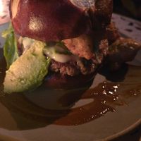 Burger with avocado, jalapenos, and crispy mushrooms at Om Sabor in San Francisco