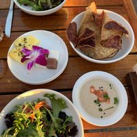 Salad, pineapple with black pepper, coconut and taro cubes, taro chips, garlic hummus   at Old Lahaina Luau in Lahaina