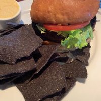 Burger with chips and hummus side  at Ethos Vegan Kitchen in Winter Park