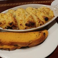 Huge portion of sheppard's pie served with jalapeno cheese bread at Ethos Vegan Kitchen in Winter Park