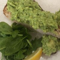 Avocado on toast (half eaten) without black pepper and chilli for our 6 year old   at 269 Vegan in Perth