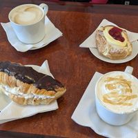 Latte (top left), cherry danish (top right), chocolate dipped, whipped cream filled croissant (bottom left), caramel macchiato (bottom right) at Vegan Danish Bakery in Toronto