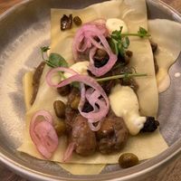 Open ravioli with mushroom ragout, fava beans and vegan parmesan cream.   at Lento in Hasselt