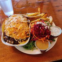 Chilaquiles enchilada, potato wedges and miso gravy, salad with poppy seed dressing at The Naam in Vancouver