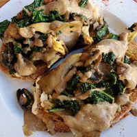 Mixed oyster mushroom bring with spinach and tarragon cream on sourdough toast at Hullabaloo in Ipswich